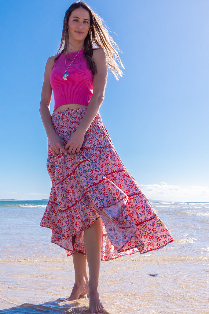 Swirl softly into the new season wearing the lovely Rozita Pink Tiered Maxi Skirt. Airy and sweet, this gorgeous separate will see you through spring and summer in effortless style and complete comfort. Cotton, shirred waistband, pockets, pink floral print and red ric-rac feature.