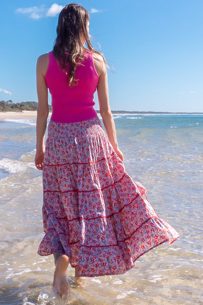 Swirl softly into the new season wearing the lovely Rozita Pink Tiered Maxi Skirt. Airy and sweet, this gorgeous separate will see you through spring and summer in effortless style and complete comfort. Cotton, shirred waistband, pockets, pink floral print and red ric-rac feature.