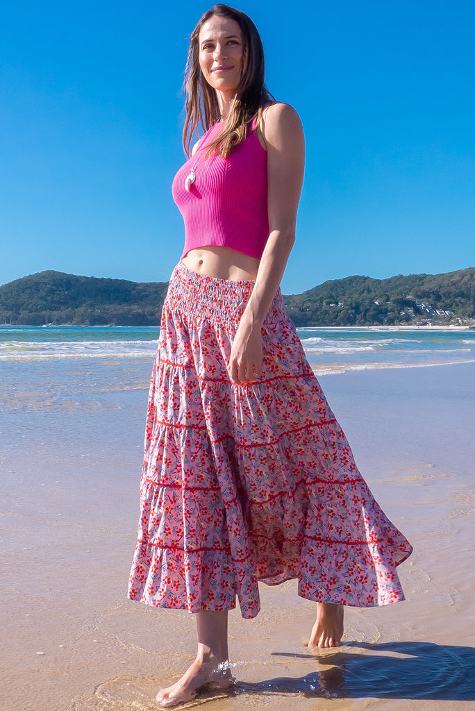 Swirl softly into the new season wearing the lovely Rozita Pink Tiered Maxi Skirt. Airy and sweet, this gorgeous separate will see you through spring and summer in effortless style and complete comfort. Cotton, shirred waistband, pockets, pink floral print and red ric-rac feature.