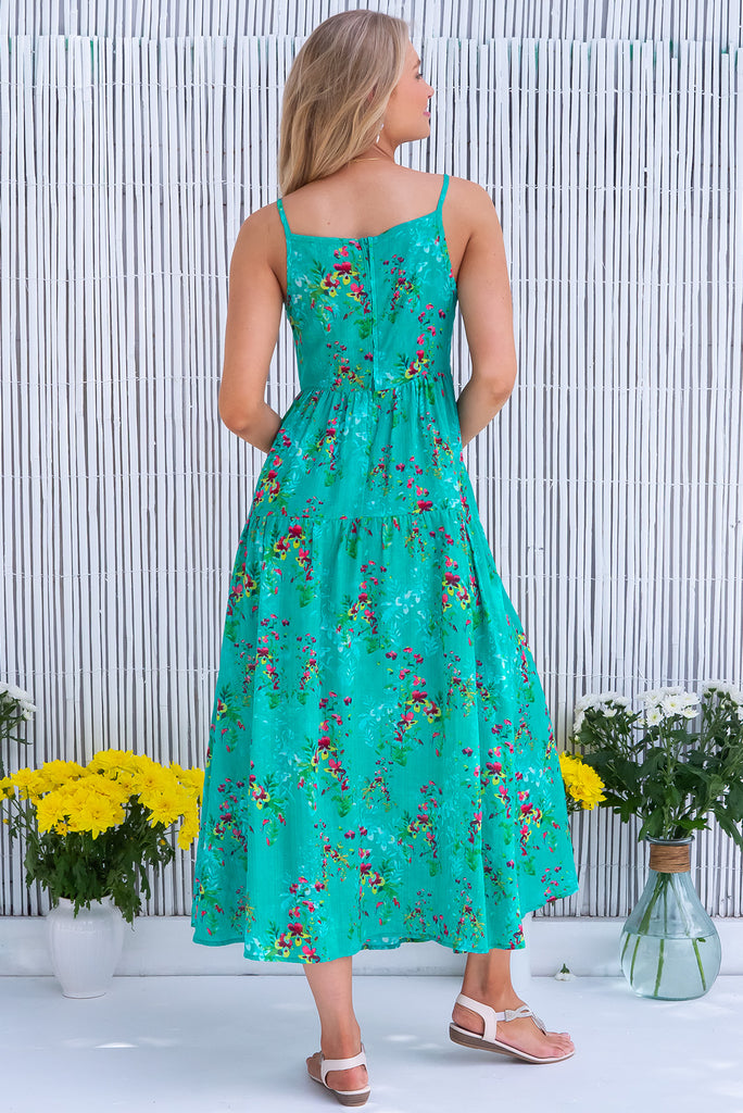 The Solana Green Seas Maxi Dress is a gorgeous sea green maxi dress with a botanical floral print and wash effect base. The dress features a v-neckline, fitted bust, back zipper, flow skirt and side pockets. Made from a woven blend of cotton and rayon.