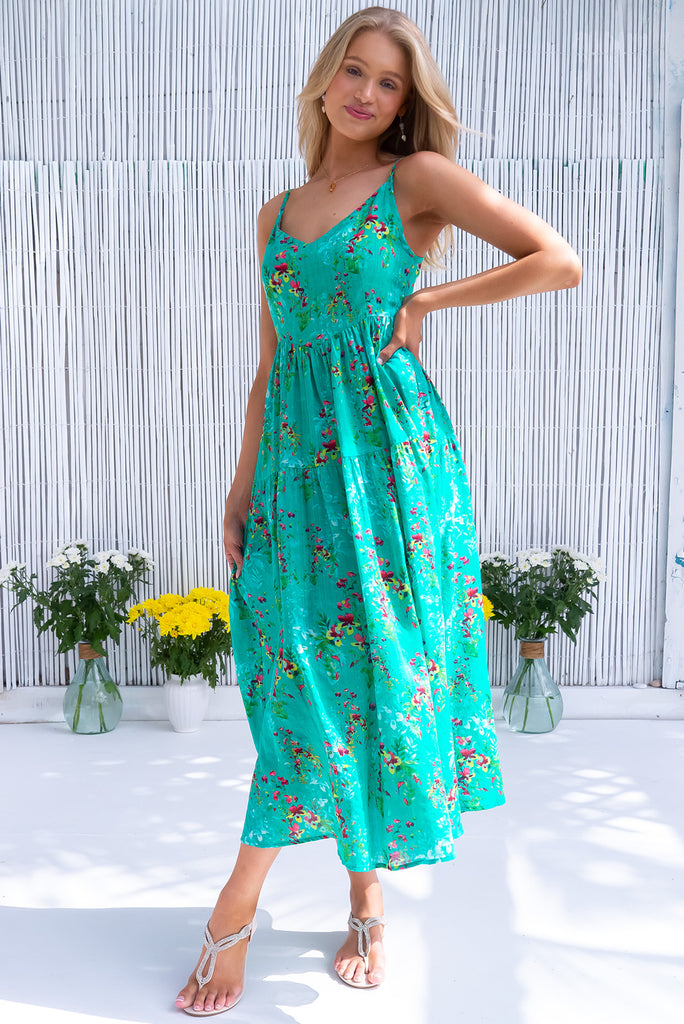 The Solana Green Seas Maxi Dress is a gorgeous sea green maxi dress with a botanical floral print and wash effect base. The dress features a v-neckline, fitted bust, back zipper, flow skirt and side pockets. Made from a woven blend of cotton and rayon.