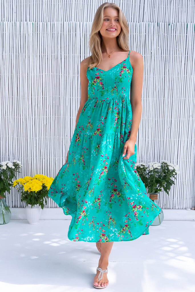 The Solana Green Seas Maxi Dress is a gorgeous sea green maxi dress with a botanical floral print and wash effect base. The dress features a v-neckline, fitted bust, back zipper, flow skirt and side pockets. Made from a woven blend of cotton and rayon.
