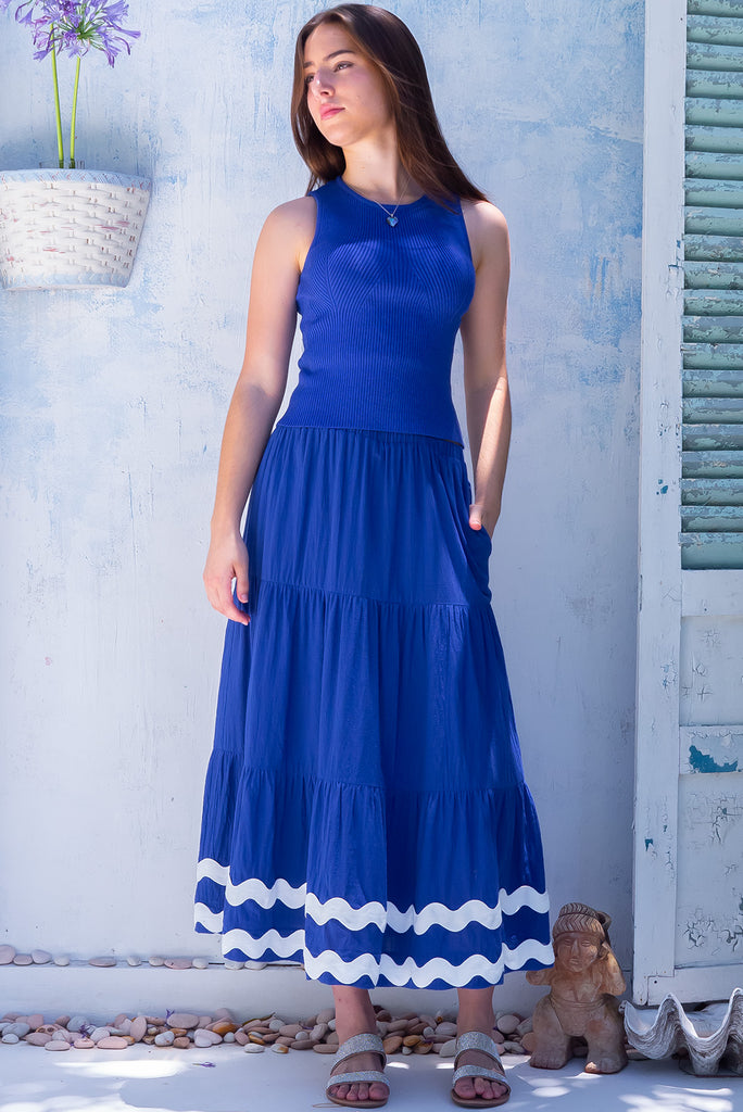 The Sorrento Ric Rac Cobalt Maxi Skirt is a beautiful blue maxi skirt with white oversized ric rac detailing on the hem. The skirt features tiering and an elasticated waistband. Made from 100% cotton.
