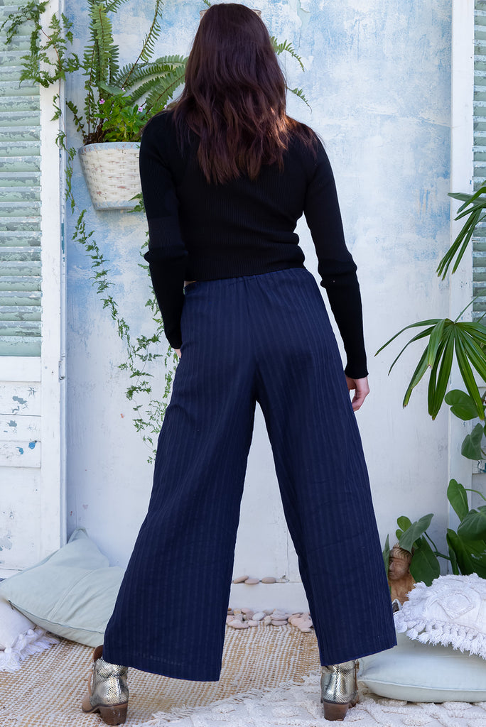 The Traveller Sonar Blue Pants are a beautiful navy blue pair of mid-rise cargo style pants. The pants feature an elasticated waist, side pockets, wide legs, and patch pockets. Made from 100% cotton.