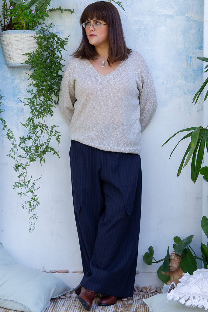 The Traveller Sonar Blue Pants are a beautiful navy blue pair of mid-rise cargo style pants. The pants feature an elasticated waist, side pockets, wide legs, and patch pockets. Made from 100% cotton.