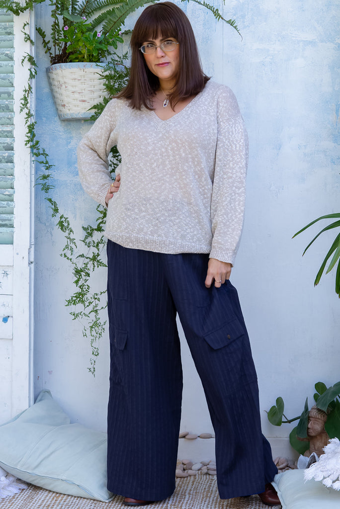 The Traveller Sonar Blue Pants are a beautiful navy blue pair of mid-rise cargo style pants. The pants feature an elasticated waist, side pockets, wide legs, and patch pockets. Made from 100% cotton.