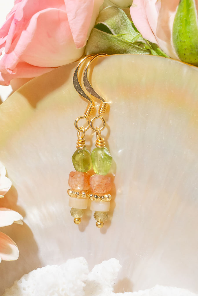 The Earrings Golden Droplet Peridot are a gorgeous pair of handmade earrings featuring periodic, natural sunstone and mother of pearl.