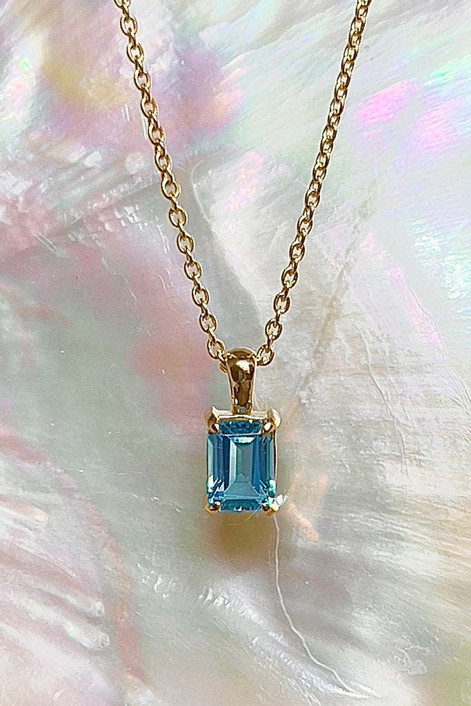 The pendant and chain are 9ct gold vermeil on a base of 925 silver, the gold is 2.5microns thick so will never rub or discolor An emerald cut Blue Topaz gemstone set in 9ct gold vermeil. Swiss blue Topaz gemstone. Pendant is 4cm long. Chain is gold vermeil