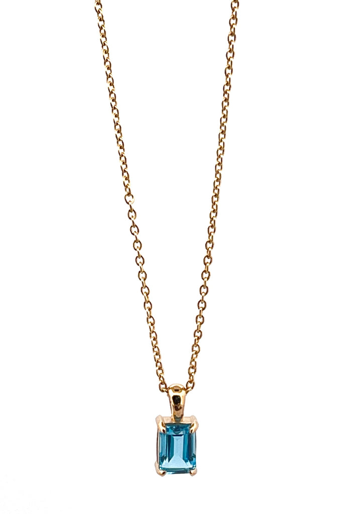 The pendant and chain are 9ct gold vermeil on a base of 925 silver, the gold is 2.5microns thick so will never rub or discolor An emerald cut Blue Topaz gemstone set in 9ct gold vermeil. Swiss blue Topaz gemstone. Pendant is 4cm long. Chain is gold vermeil