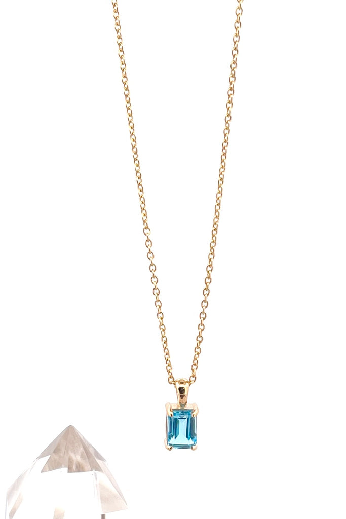 The pendant and chain are 9ct gold vermeil on a base of 925 silver, the gold is 2.5microns thick so will never rub or discolor An emerald cut Blue Topaz gemstone set in 9ct gold vermeil. Swiss blue Topaz gemstone. Pendant is 4cm long. Chain is gold vermeil