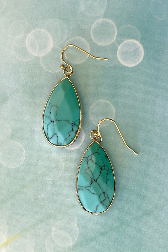 These earrings in Turquoise simulant are bezel set in gold tone, a perfect summer boho style.