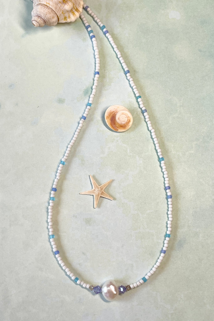  A delicate choker style necklace made with tiny sand seed beads, with a pearl and Swarovski crystal centre piece.
