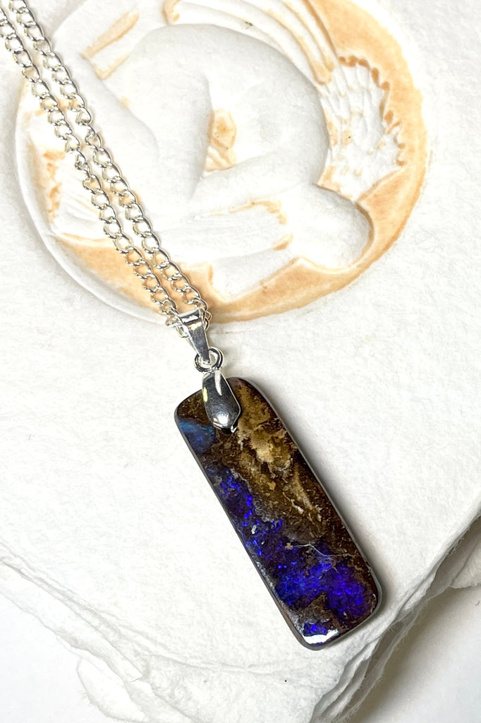 Comes on a silver snake chain. A very organic natural piece of Boulder Opal with a strong flash of dark blue crystal across the centre.