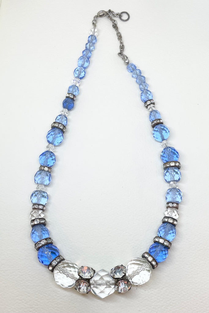 This beautiful necklace is made with crystal beads in a lovely clear blue colour, and three large clear crystal faceted beads. There are old diamante spacers