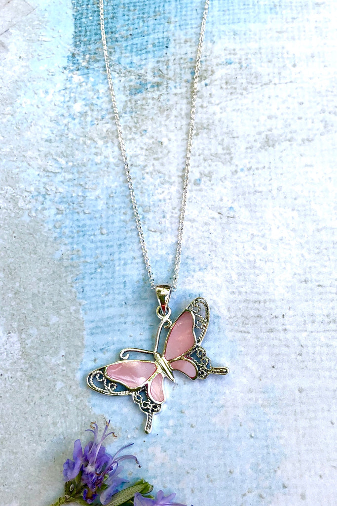 A charming butterfly necklace in shiny silver, with inlaid Mother of Pearl shell in palest pink..  