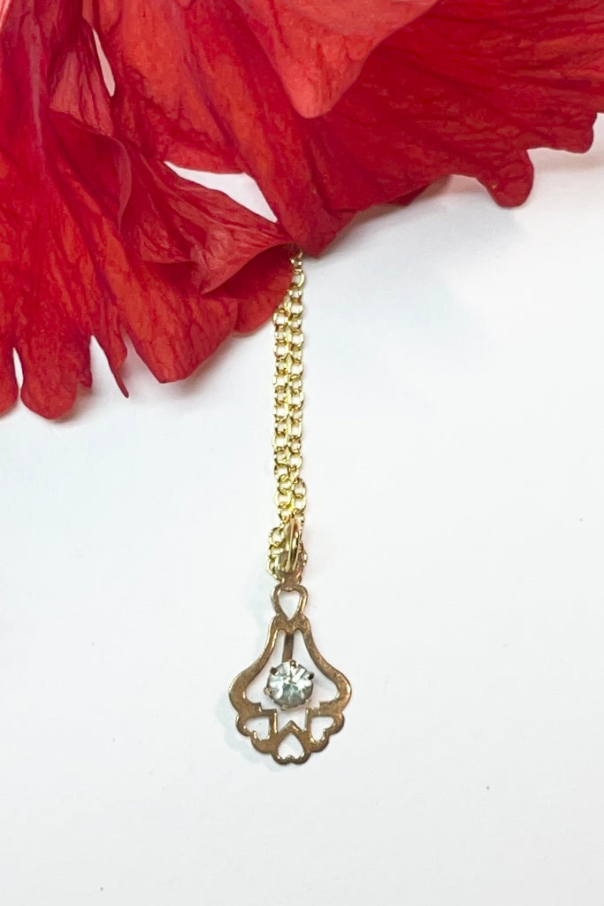 A small silver vintage pendant, flash plated with a diamante centre and a row of hearts at the base.