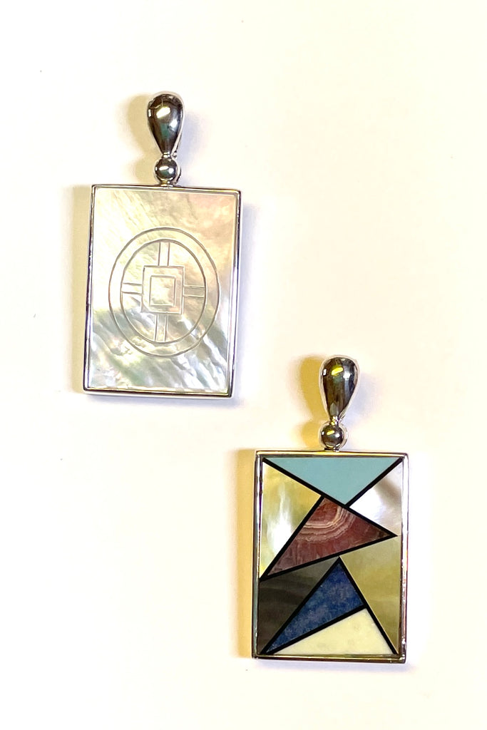  silver and shell inlay pendant is unique and handmade. Each piece is slightly different, the mosaics are in the same order but stone patterns may vary. On the reverse side is a beautiful piece of Mother of Pearl shell inscribed with a pattern.