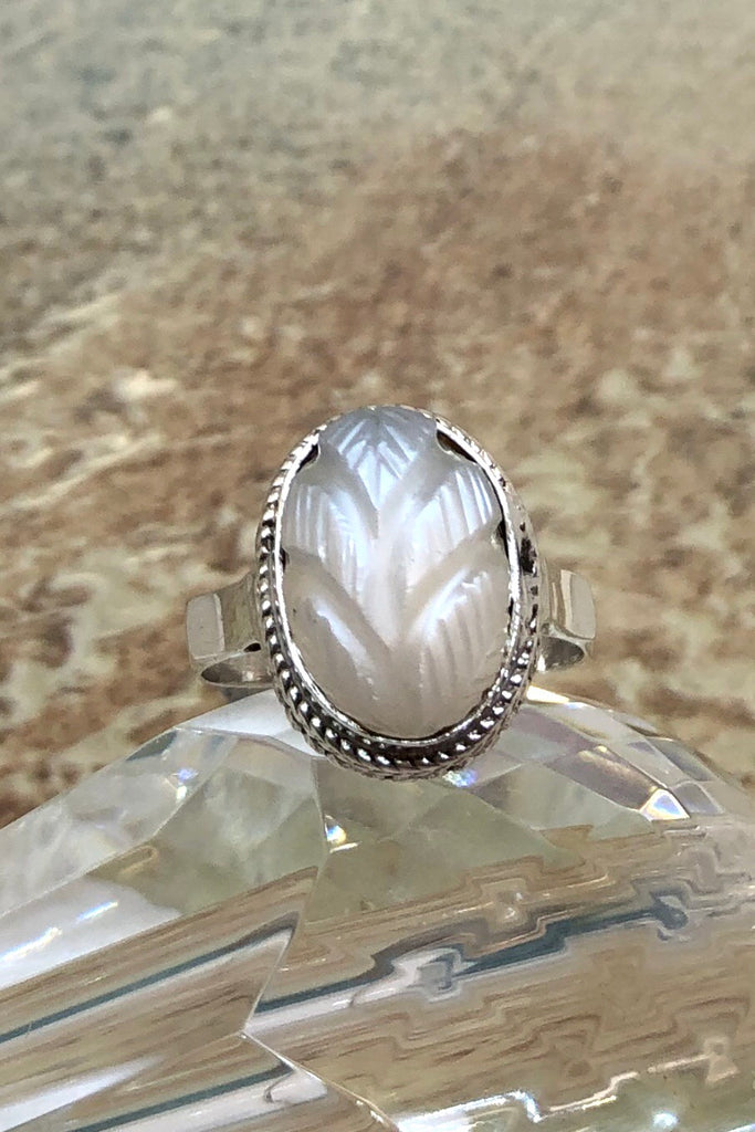 The Echo Ring Moonstone Carving is a handmade moonstone cabachon ring featuring set in silver with a hand carved leaf design.