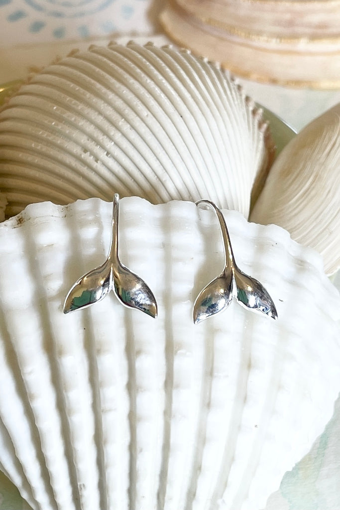 Silver earring whale tail.