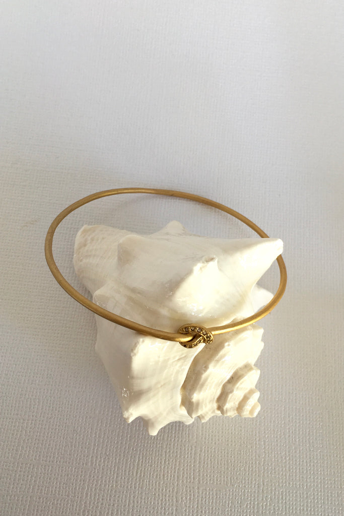 This adorable bangle has Luna appeal it is handcrafted in gold plated  silver vermeil. The gems are studded randomly and will sparkle at different angles