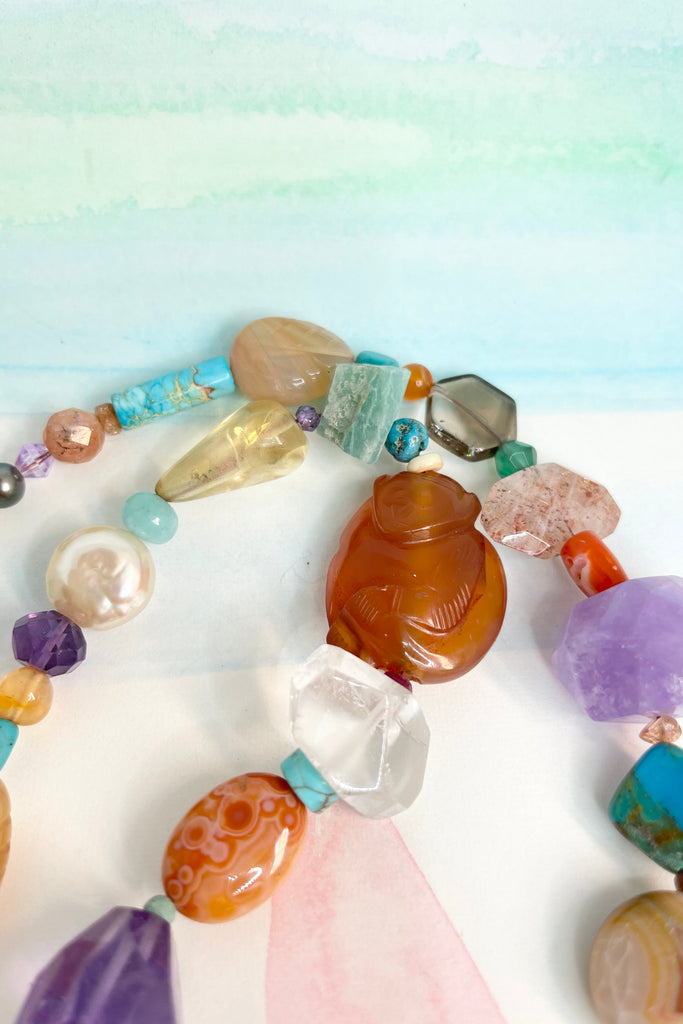 Beads are - Strawberry Quartz, Smokey Quartz, Pearl, Amazonite, Peruvian Agate, Amethyst, Carnelian, Agate, natural Sunstone, Ametrine, clear Rock Crystal, Green glass from South Africa, Natural genuine Turquoise - the centre turquoise bead is very old.