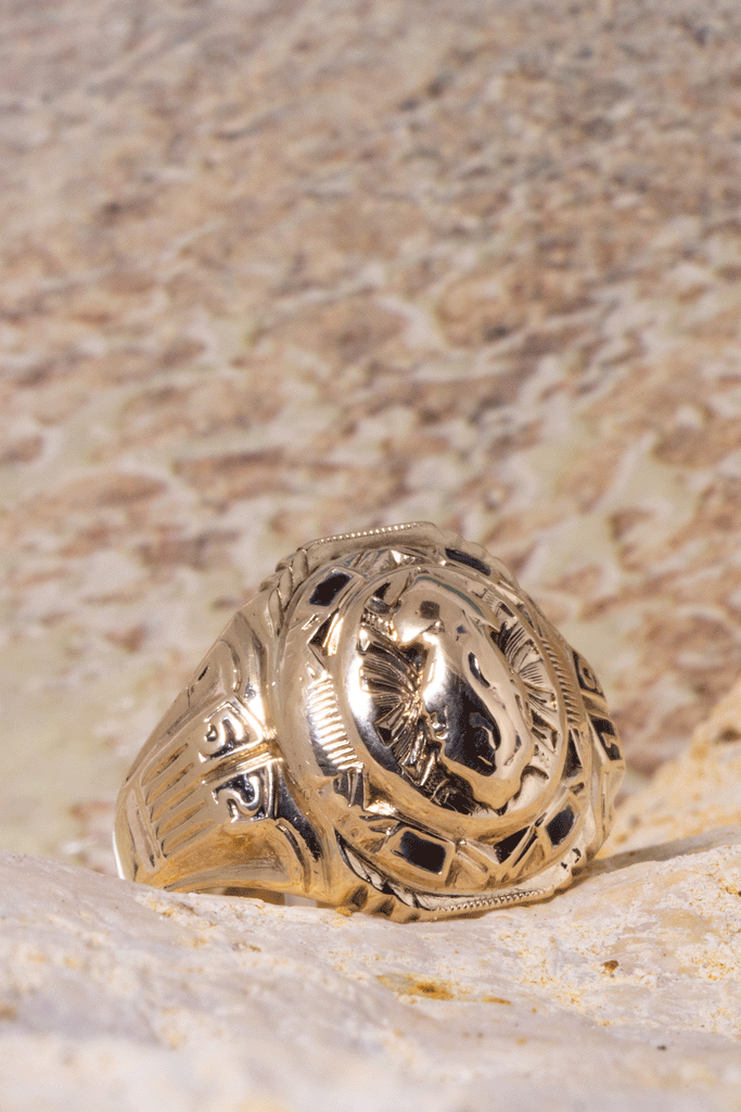 Vintage university ring with the date 1952, a raised crest of a flame centrepiece