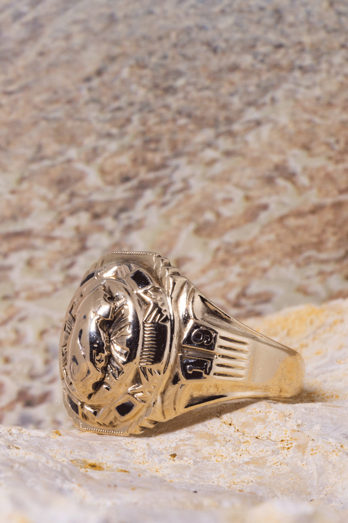 Vintage university ring with the date 1952, a raised crest of a flame centrepiece