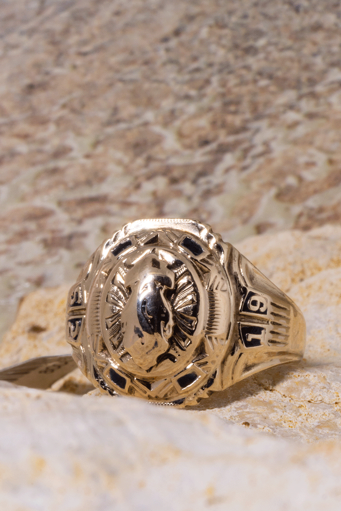 Vintage university ring with the date 1952, a raised crest of a flame centrepiece