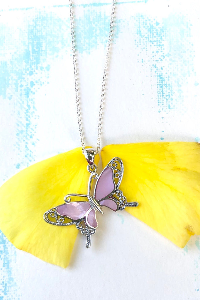 A charming butterfly necklace in shiny silver, with inlaid Mother of Pearl shell in palest pink..  