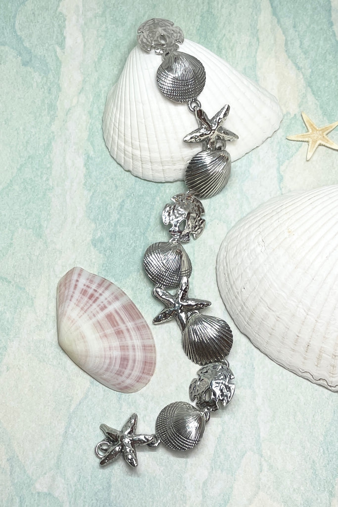 925 solid silver seashells starfish and sand dollars all connected around the wrist to create this unique and beautiful bracelet.