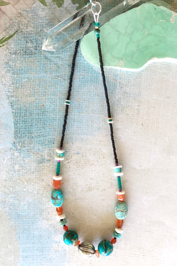 Necklace Cay Silver Ball has gorgeous beads including Carnelian, turquoise coloured howlite stone, shell and Turkish glass beads and hill tribe silver centre piece in the shape of a ball with stamping detail.