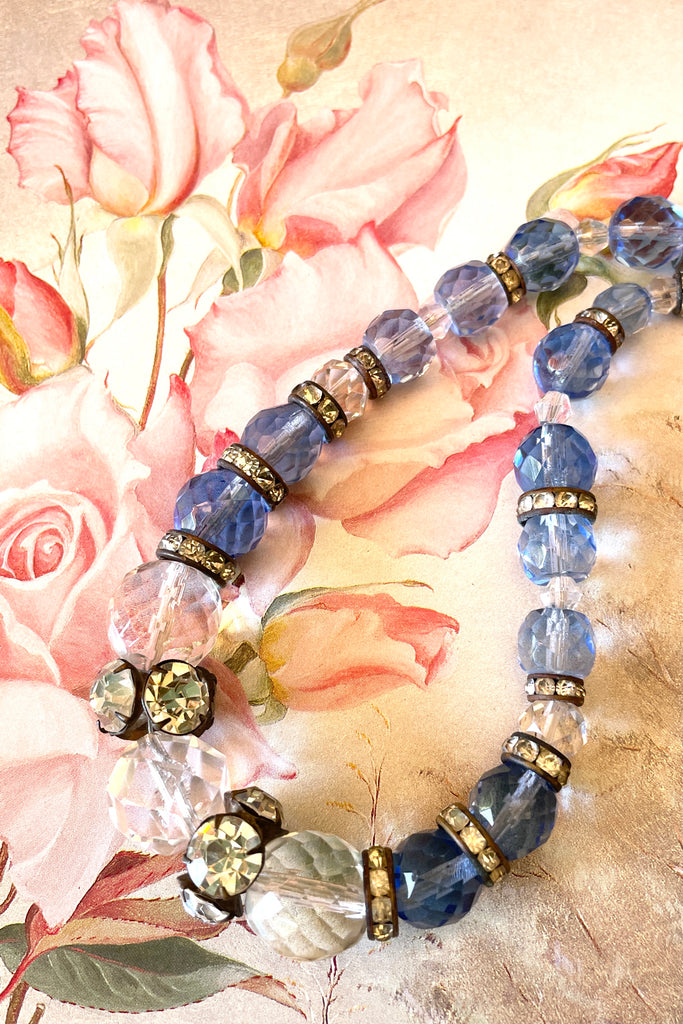 This beautiful necklace is made with crystal beads in a lovely clear blue colour, and three large clear crystal faceted beads. There are old diamante spacers
