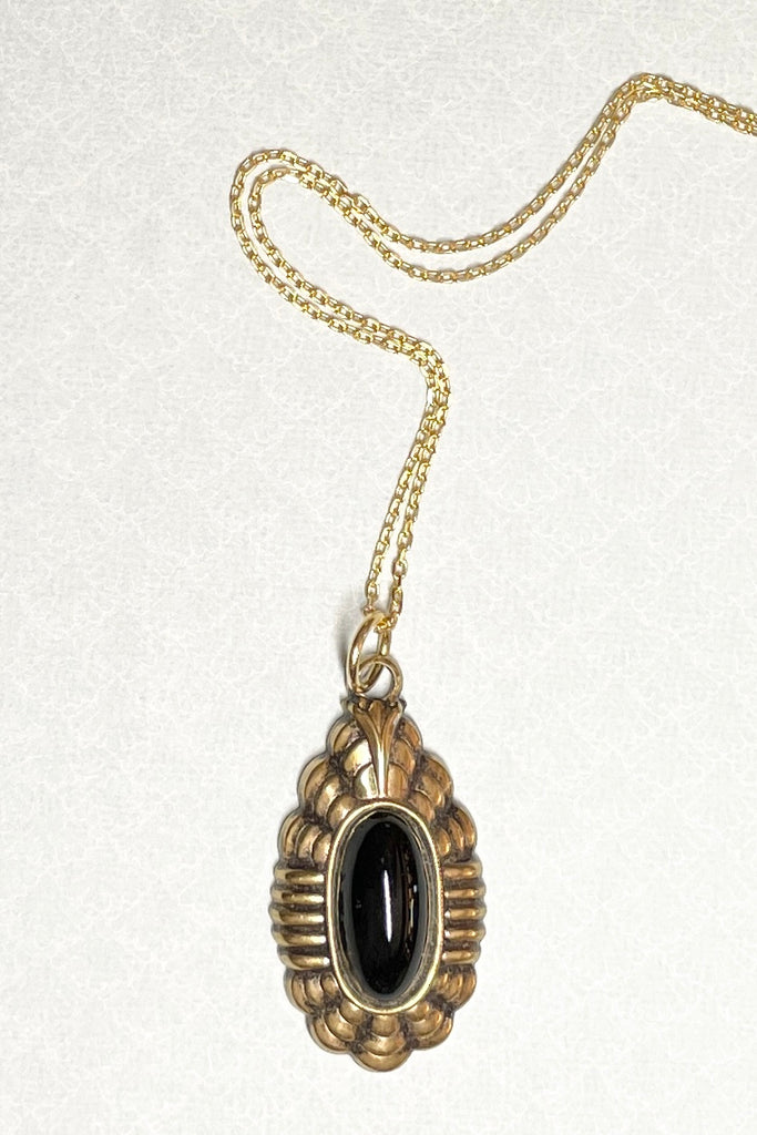 Be the chic grand lady wearing this Victorian style black and gold pendant, it comes on a chain. Retro jewellery in good condition.
