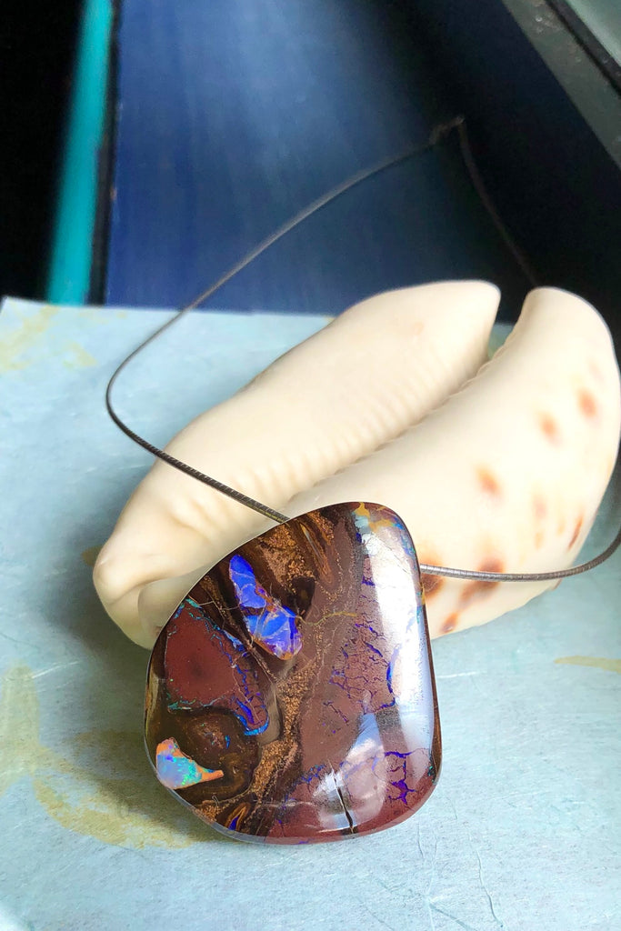  this intriguing piece of Boulder Opal was mined, cut and polished in Queensland. The flashes of colour give one a glimpse into the past. 