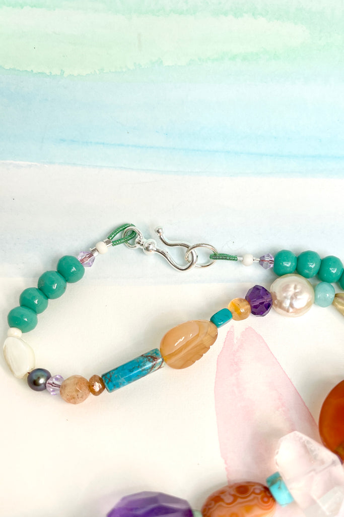 Beads are - Strawberry Quartz, Smokey Quartz, Pearl, Amazonite, Peruvian Agate, Amethyst, Carnelian, Agate, natural Sunstone, Ametrine, clear Rock Crystal, Green glass from South Africa, Natural genuine Turquoise - the centre turquoise bead is very old.