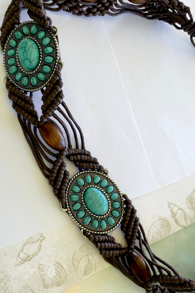 a macrame knotted and beaded belt embellished with turquoise beaded conch detail. 