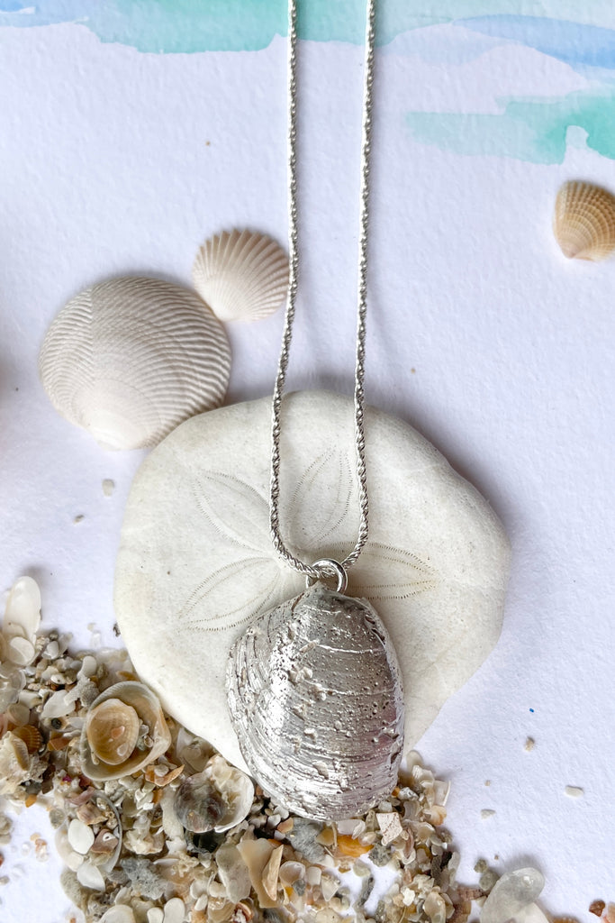  The centre piece is silver, it is cast from a little shell picked up on the Noosa beach. This pendant  is so quiet and it has a secret, the underside is enameled in deep sea blue, with a scattering of sand and rocks around the edge