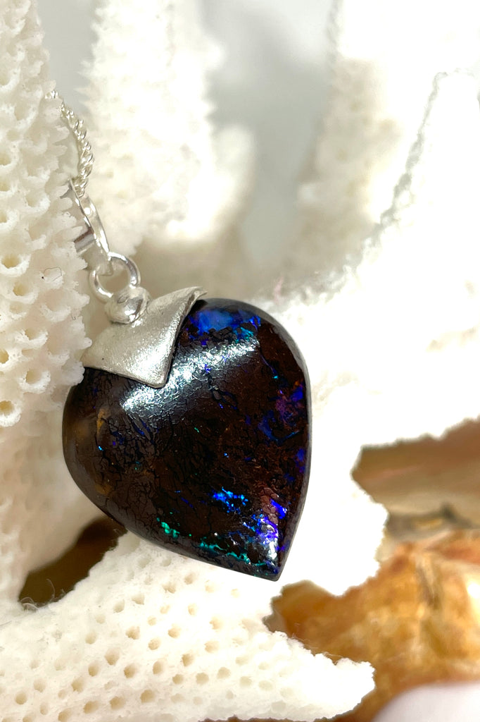 This intriguing and unique piece of opal was cut and polished into the heart shape for Mombasa Rose in Noosa, Queensland. The bright flashes of turquoise, teal and blue colour are very intense and deep in the stone, giving it a flashing twinkling look.  Very beautiful when viewed in sunlight. A very chic and modern opal pendant design. 