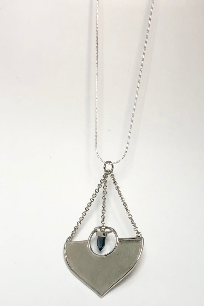 A stunning African Style 925 silver pendant with a Tourmaline Shard which hangs perfectly through a silver circle. The intense blue Tourmaline was sourced ethically from miners in Nigeria,