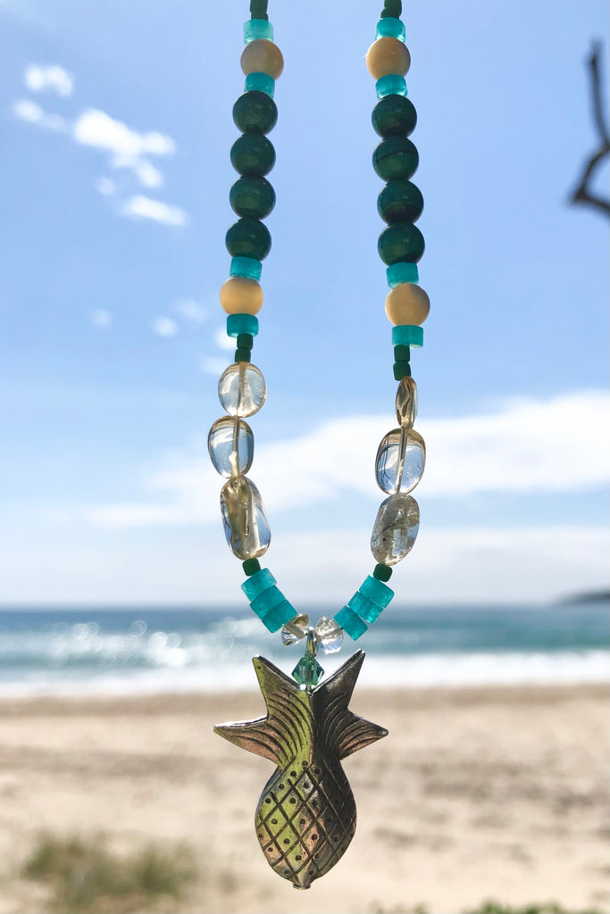 This necklace Sunny Coast inspired one off piece was made in our Noosa Studio,  There is a Thai silver pineapple as the central focus, the beads are the green, gold and turquoise of the area.