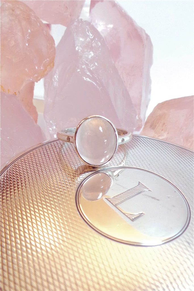 A beautiful feminine, pale luminous pink Rose Quartz gemstone ring, this darling and dainty little ring has a tiny genuine diamond set into the band on each side of the centre stone.