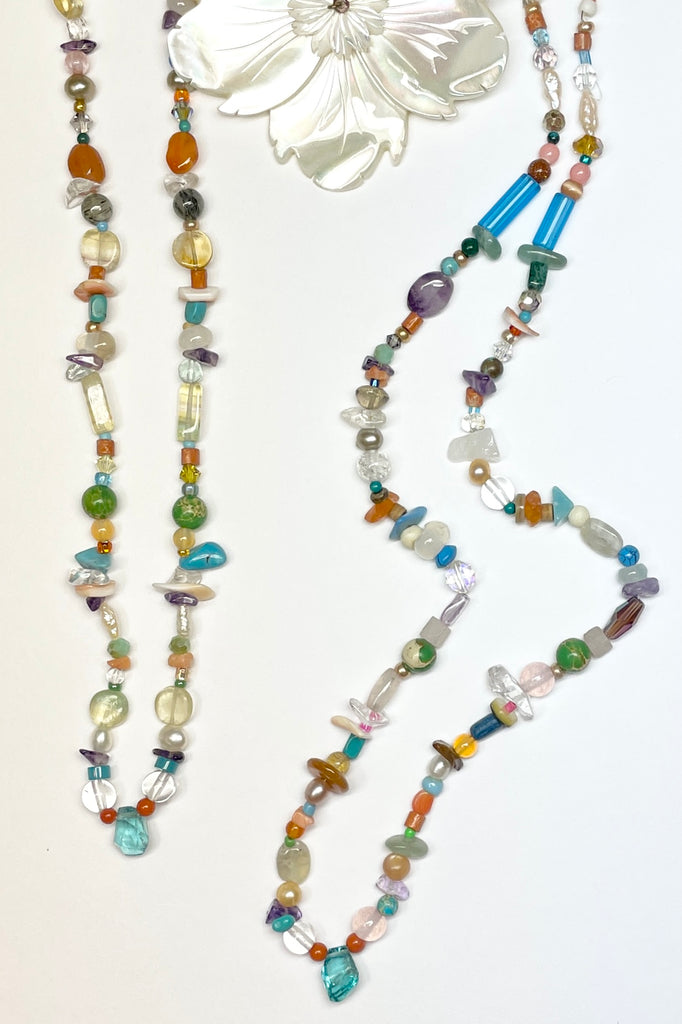 Our necklace Cay Precious is a sweet choker style hand made using random choice of gemstones, crystal, glass and shell beads in subtle mix of pretty colours. The centrepiece is a tiny bright turquoise apatite "Geo Cut" stone. 