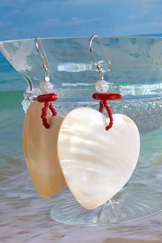 The polished Mother of Pearl shell has been hand cut into a heart shape then polished. The detal is of Red Bamboo coral, crackle rock crystal and handmade sand beads, the hook is silver.