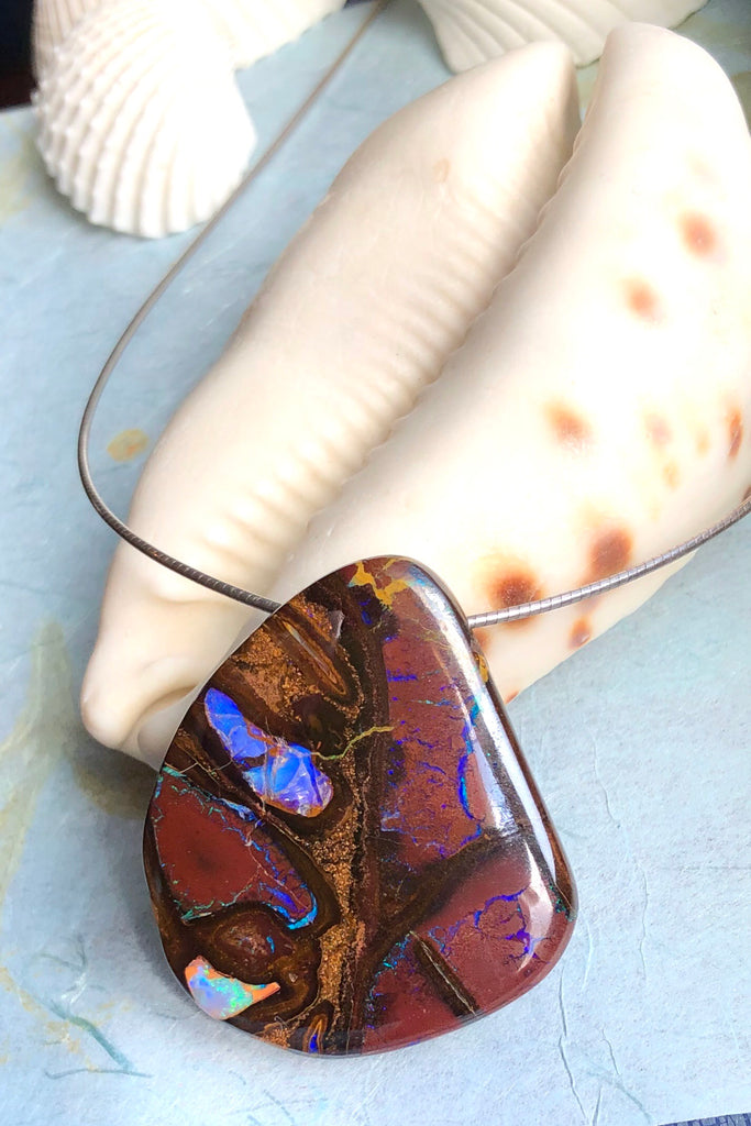  this intriguing piece of Boulder Opal was mined, cut and polished in Queensland. The flashes of colour give one a glimpse into the past. 