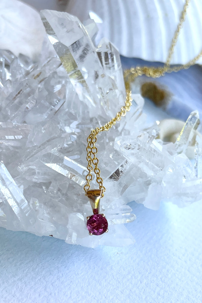 This adorable Luna pendant is made in 9ct gold, the stone is a lovely dark pink 4mm Tourmaline gemstone. A tiny delicate and sophisticated gemstone pendant.