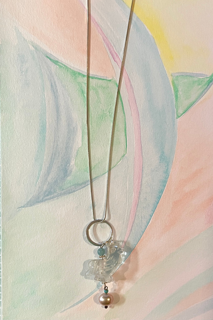 A little hand carved rock crystal rooster on a silver chain. With Amazonite and turquoise beads, a lovely pink pearl hangs at the base, this makes pendant perfection. 