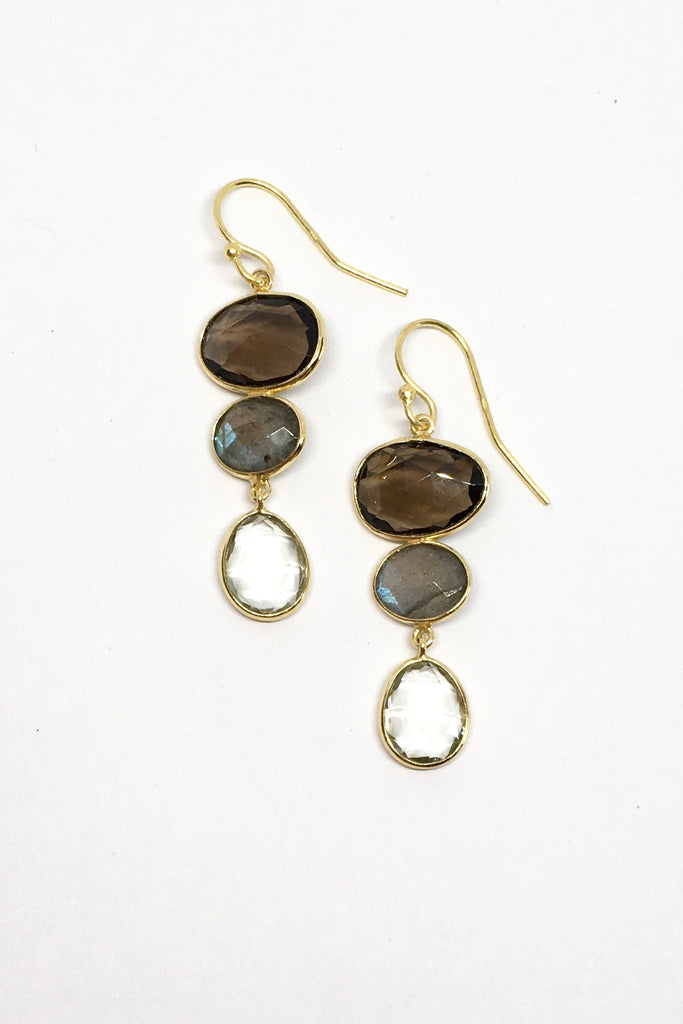 A modern bohemian inspired design of smokey toned crystal stones incased in gold vermeil