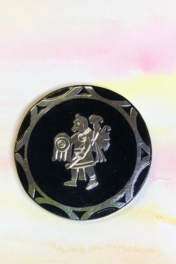 Handmade with silver warrior figure on the front and silver back.