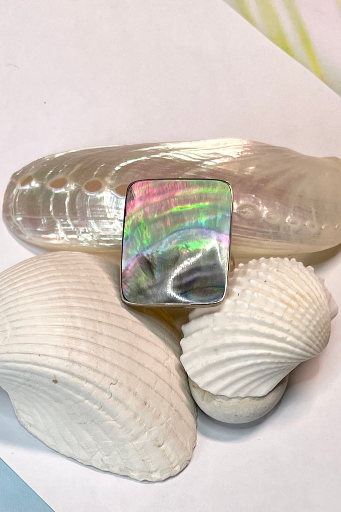 A really pretty luminescent silvery grey pink Mother of Pearl ring that catches the light in different directions. Ring is a 925 silver setting.  