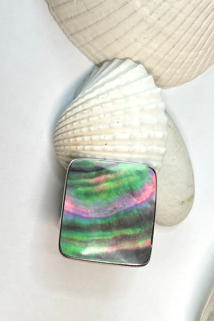 A really pretty luminescent silvery grey pink Mother of Pearl ring that catches the light in different directions. Ring is a 925 silver setting.  
